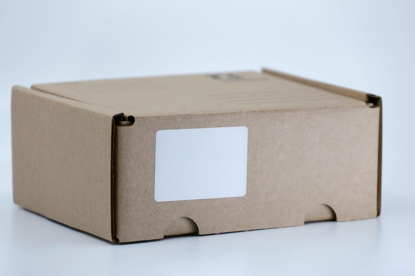 Box with a blank thermal label, set for shipping 
