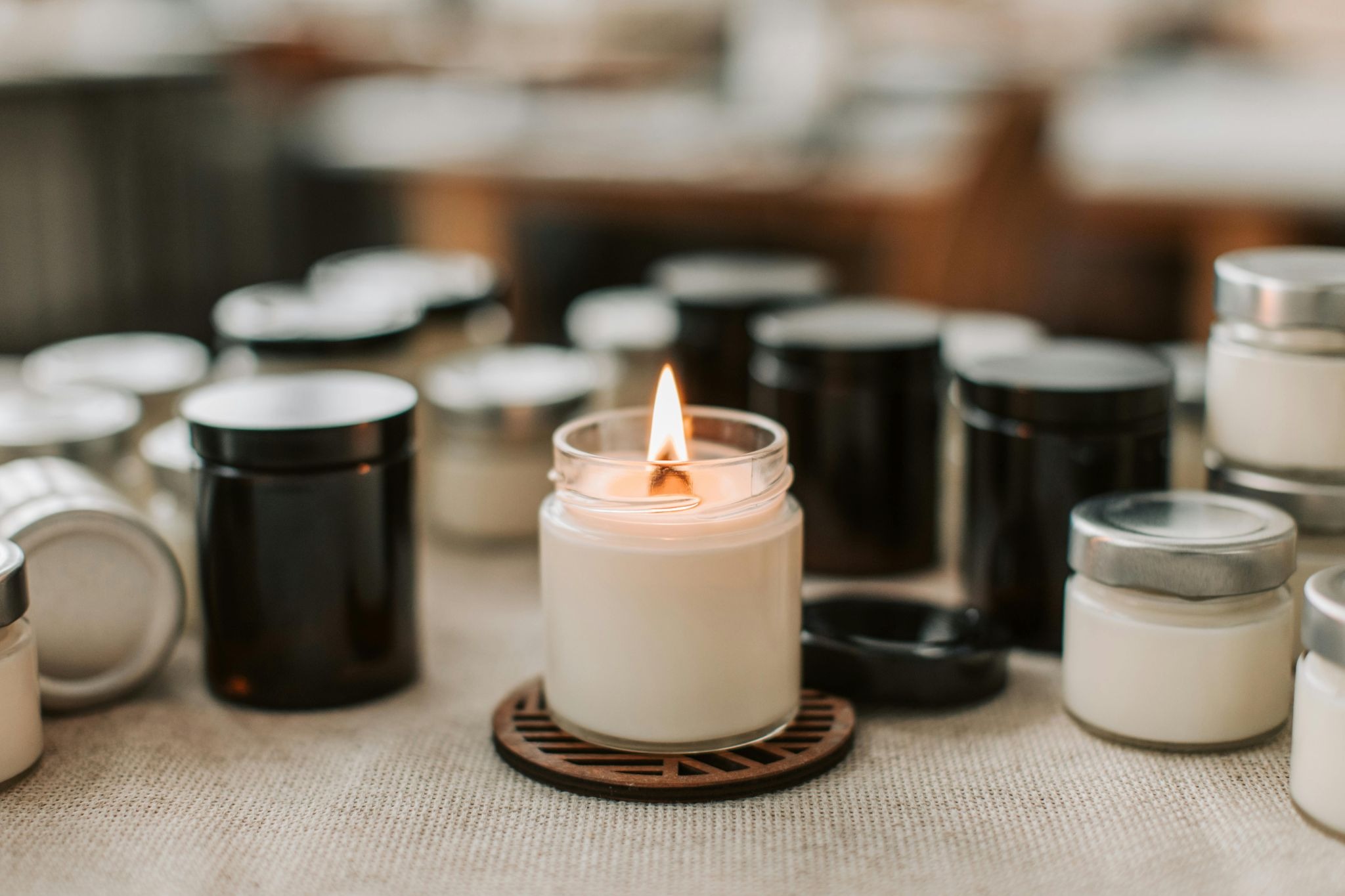 Several black and white scented candles in glass jars 