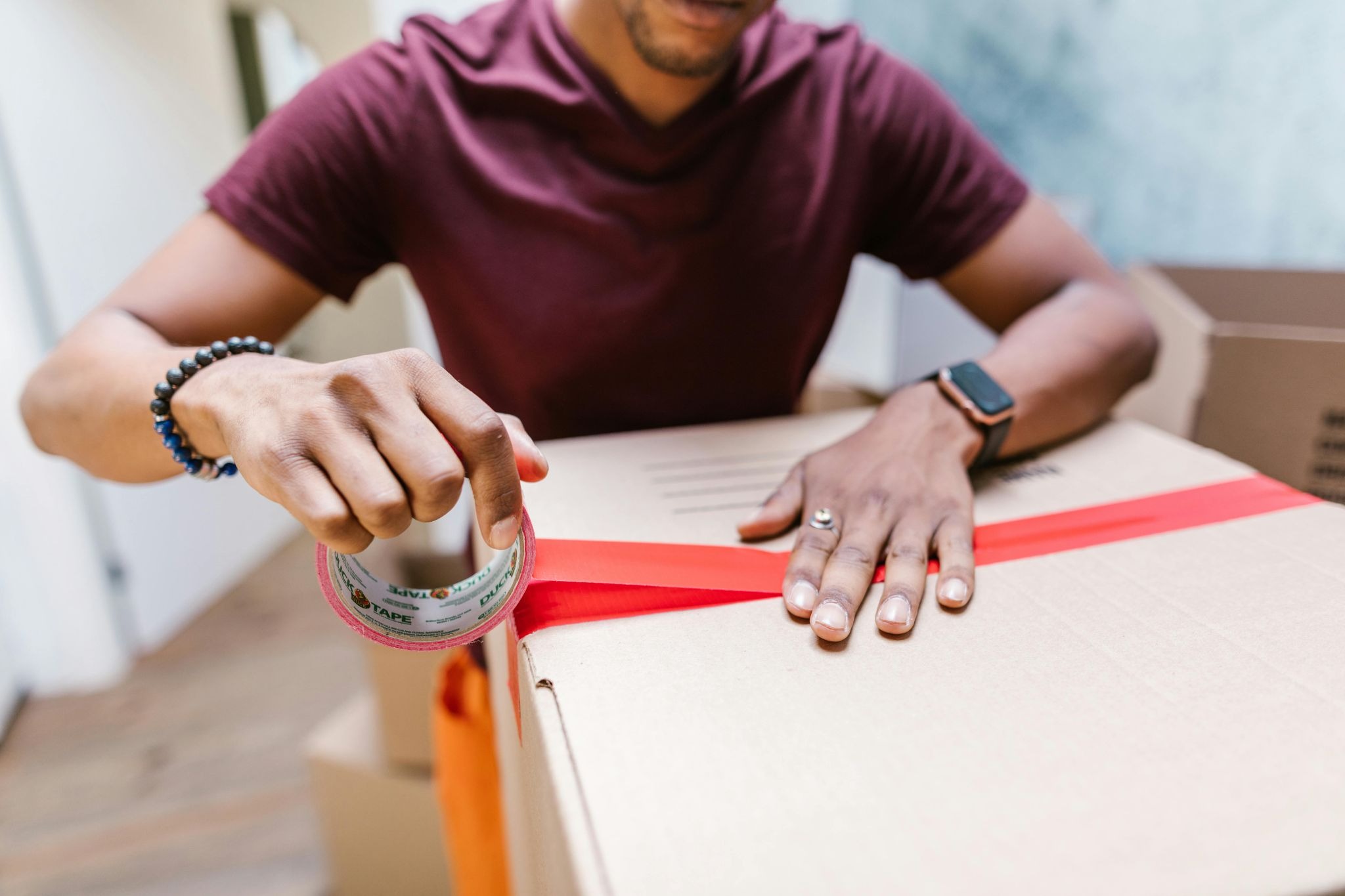 Man sealing his packaging box for shipping 