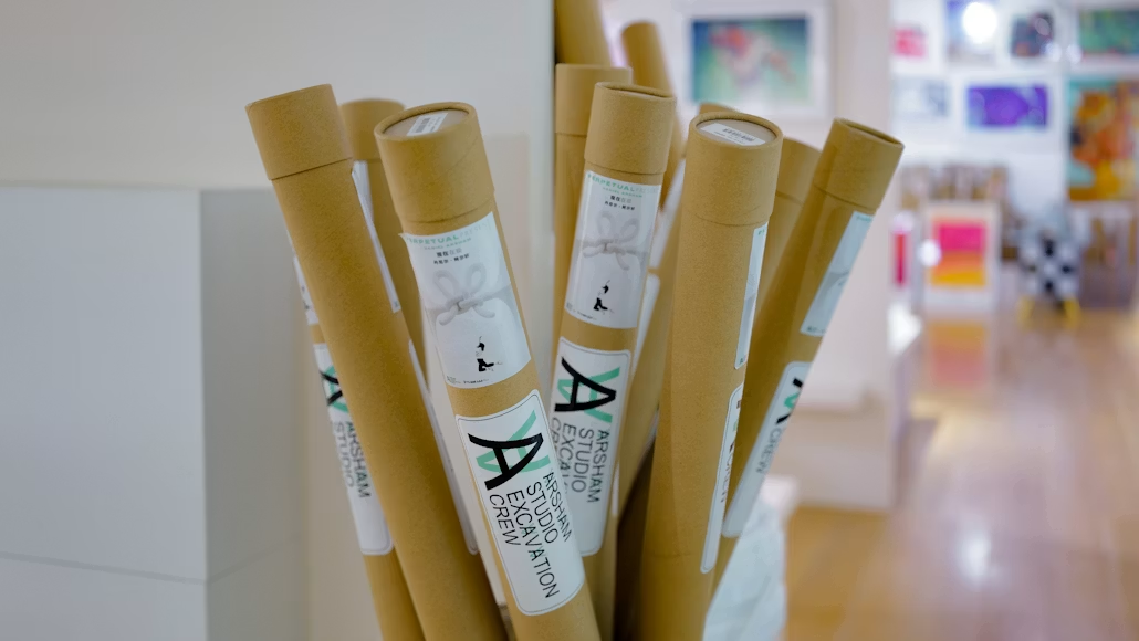 Scrolls stacked together in an art store waiting to be packed and shipped.