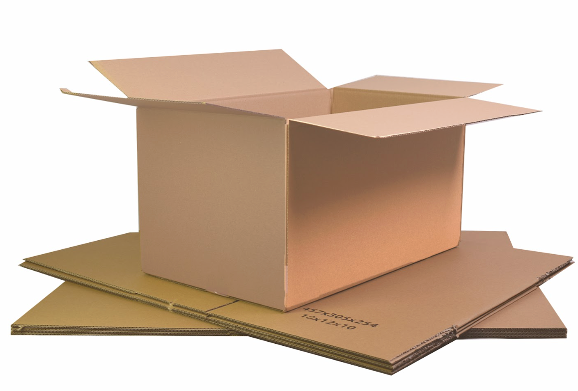 An open cardboard box placed on top of a stack of flat corrugated cardboard boxes.