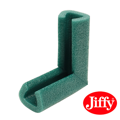 A foam corner protector shaped to fit over a frame corner, showing how it guards the most vulnerable point against drops and impacts in transit.