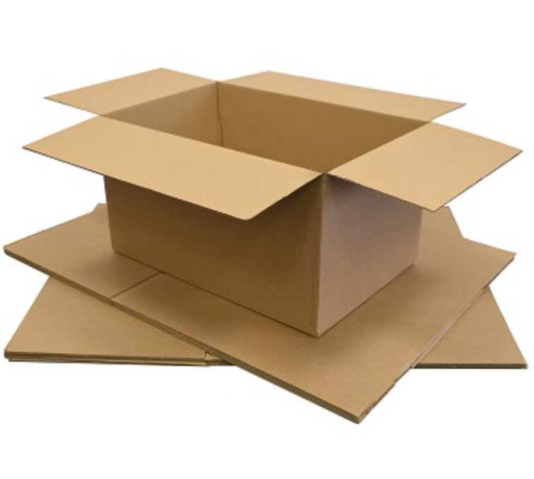 Assembled medium brown cardboard box resting on a stack of flat-packed boxes.