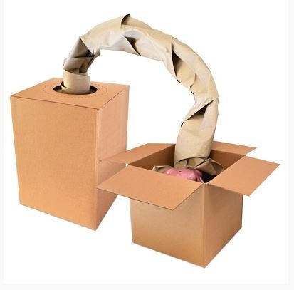 Cardboard Fill-It Box with fanfold kraft paper feeding out of the dispenser opening.