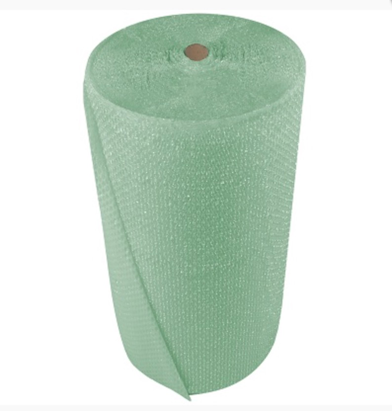  Tall roll of green biodegradable bubble wrap standing upright against a white background.