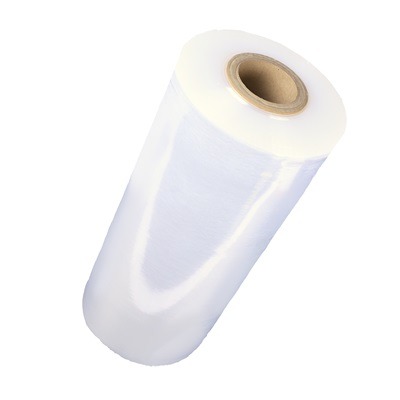 Large roll of clear machine stretch wrap on a cardboard core, used on pallet wrapping machines in busy warehouses.
